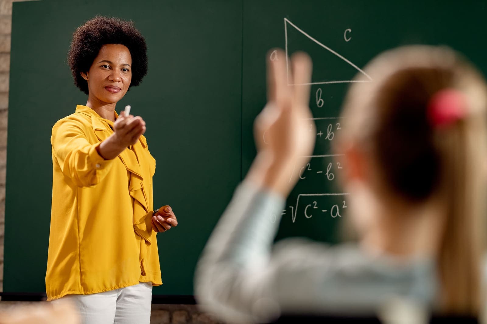 Teacher engaging students at the board